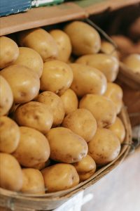 A basket full of gold potatoes.