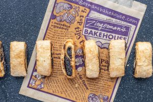 A top-down photo of a line of date rugelach resting on a Bakehouse pastry bag.